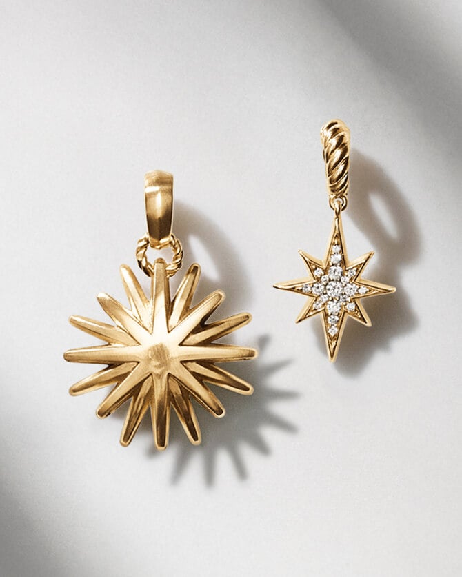Two David Yurman charms in gold.