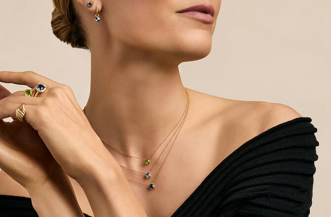 Model minimally layering David Yurman necklaces.