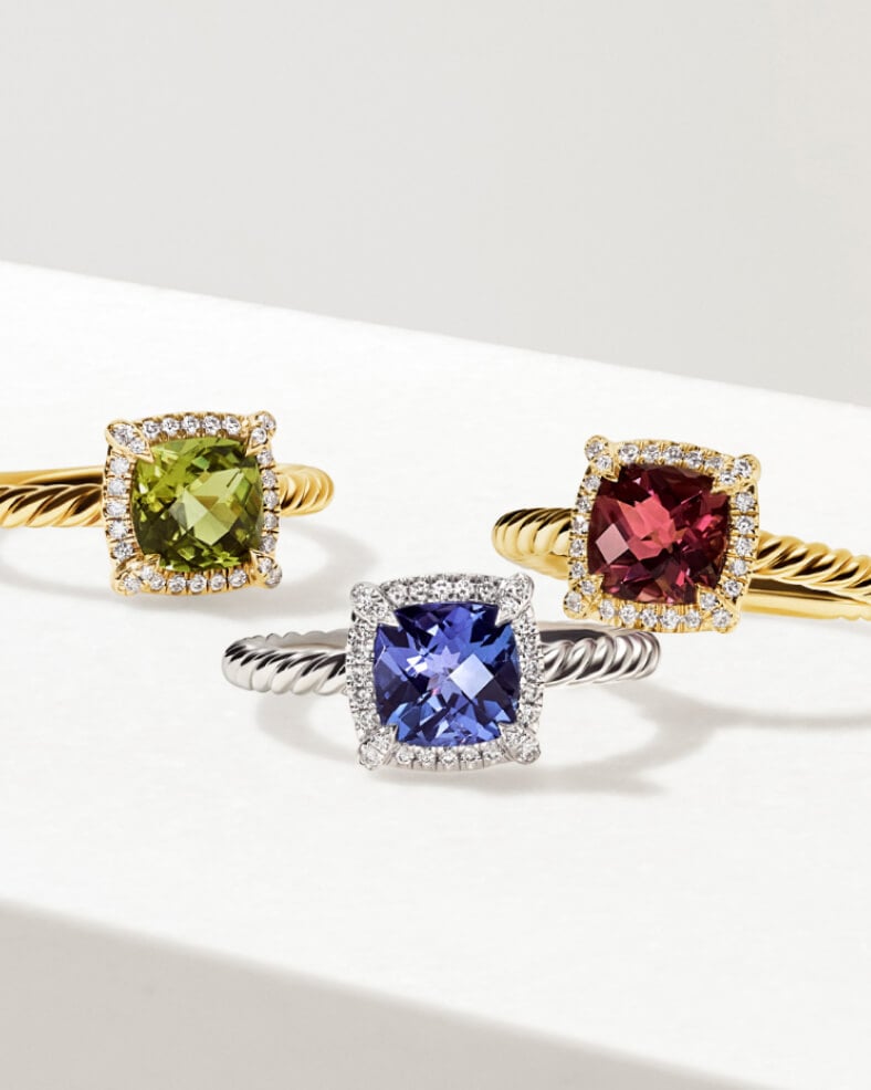 Three Chatelaine rings in various metals and gemstones.