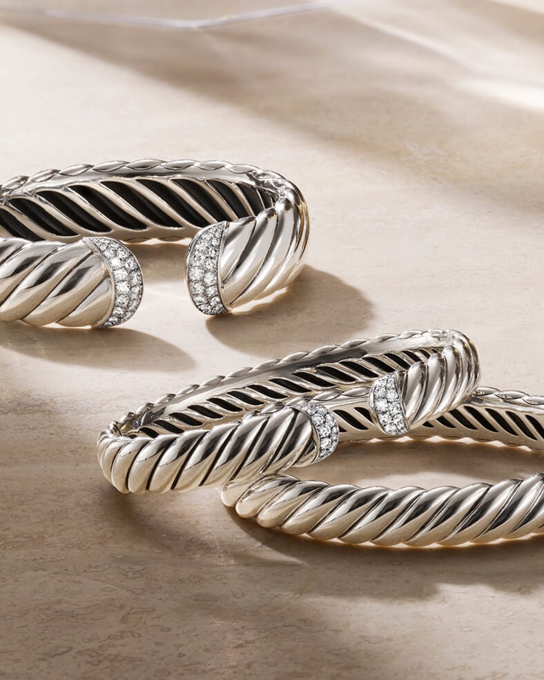 Three David Yurman bracelets.