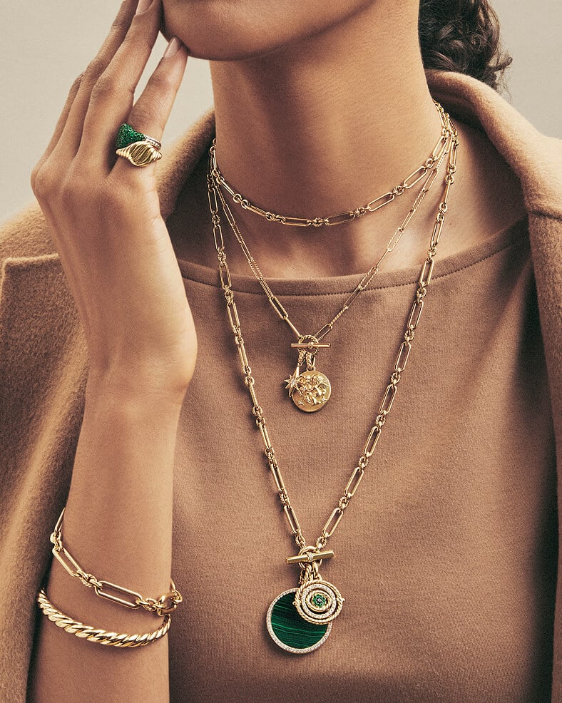 Model layering David Yurman necklaces, bracelets, and rings.