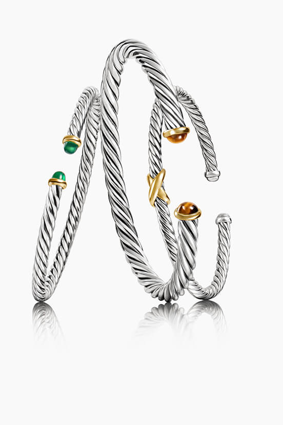 Three David Yurman bracelets.